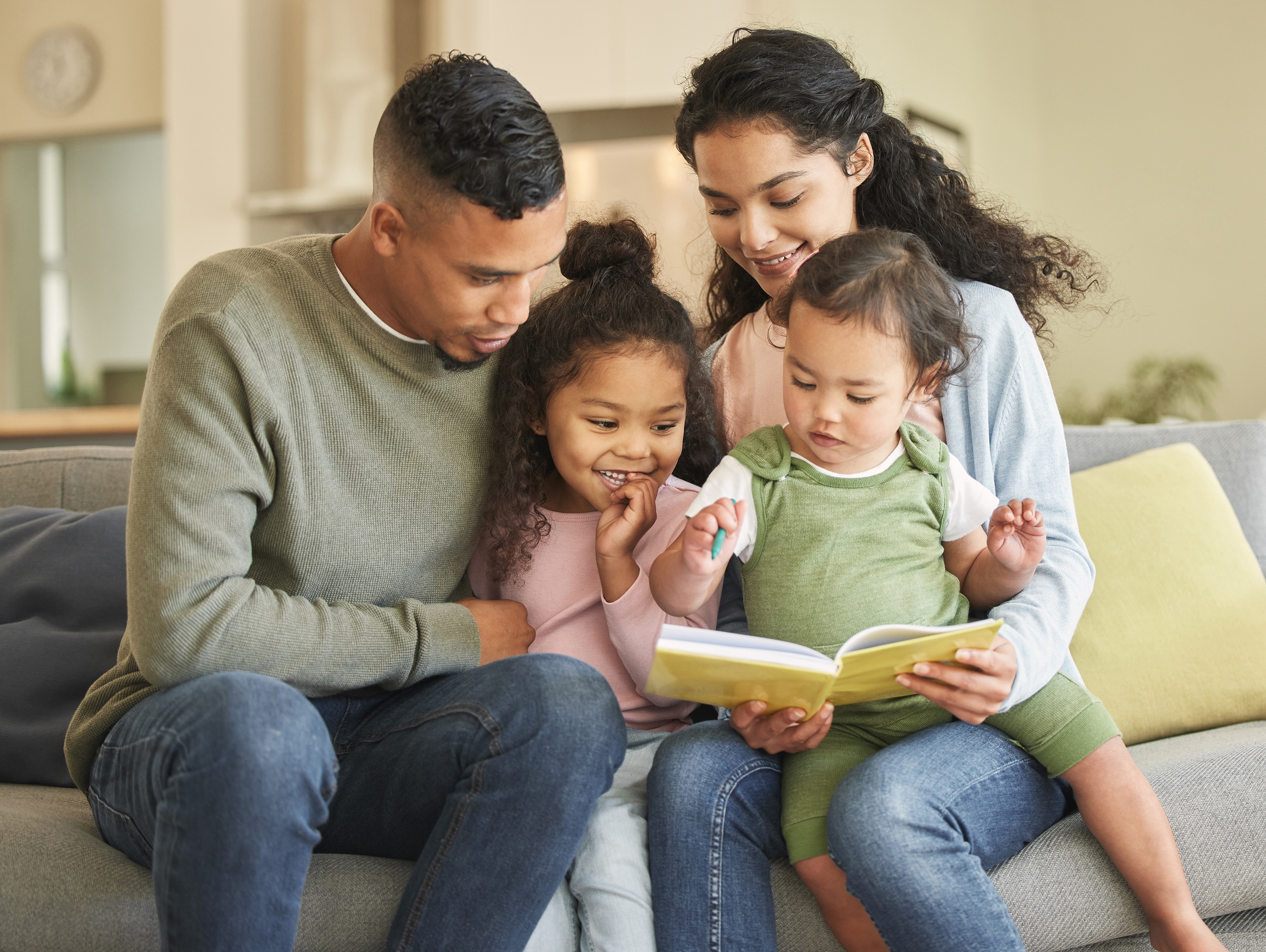 Family sitting on couch reading