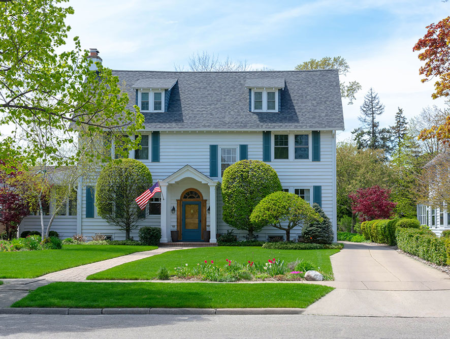 Two-story home with flag