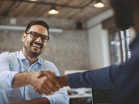 Man shaking hands with another person