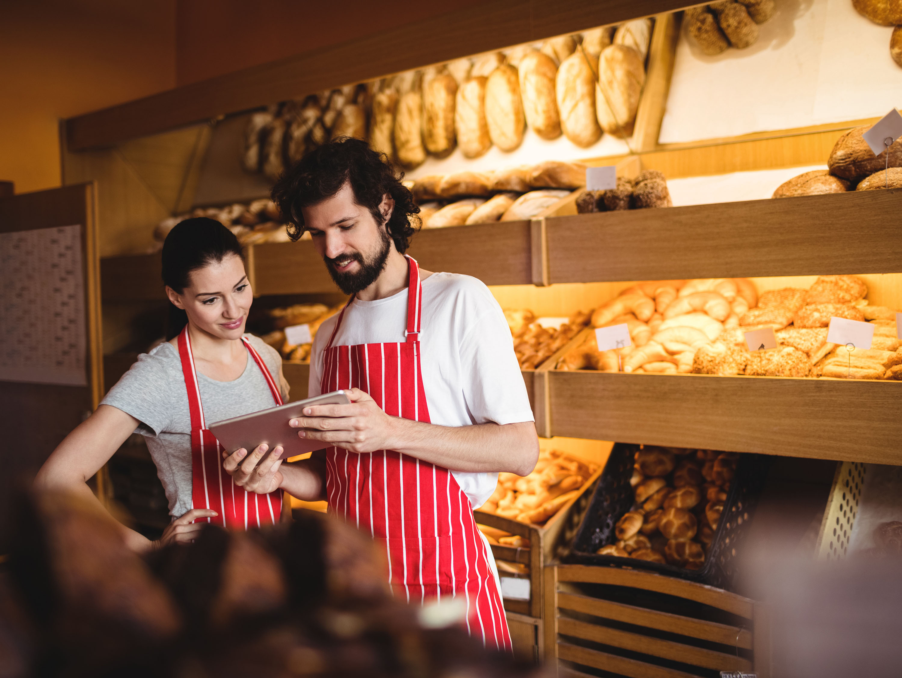 Bakery employees looking at tablet