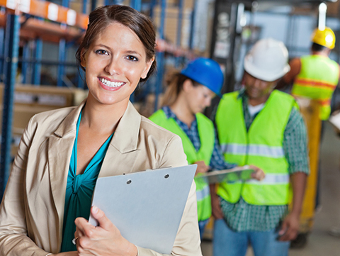 Woman holding a clipboard in a warehouse