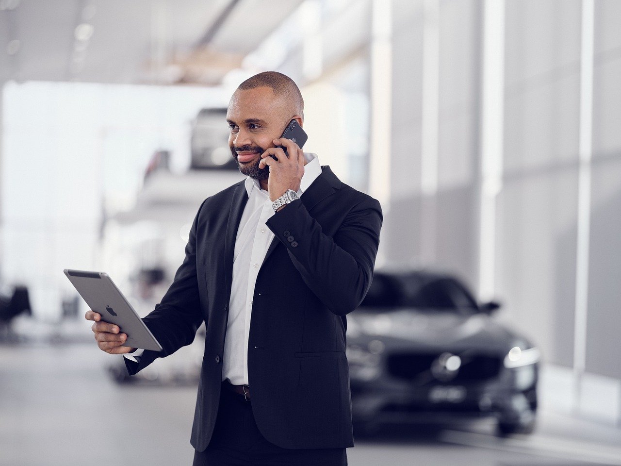 Man talking on cellphone, holding tablet