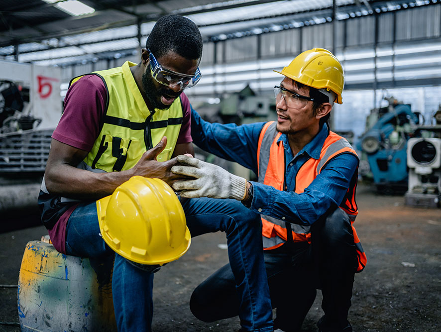 Worker consoling injured co-worker