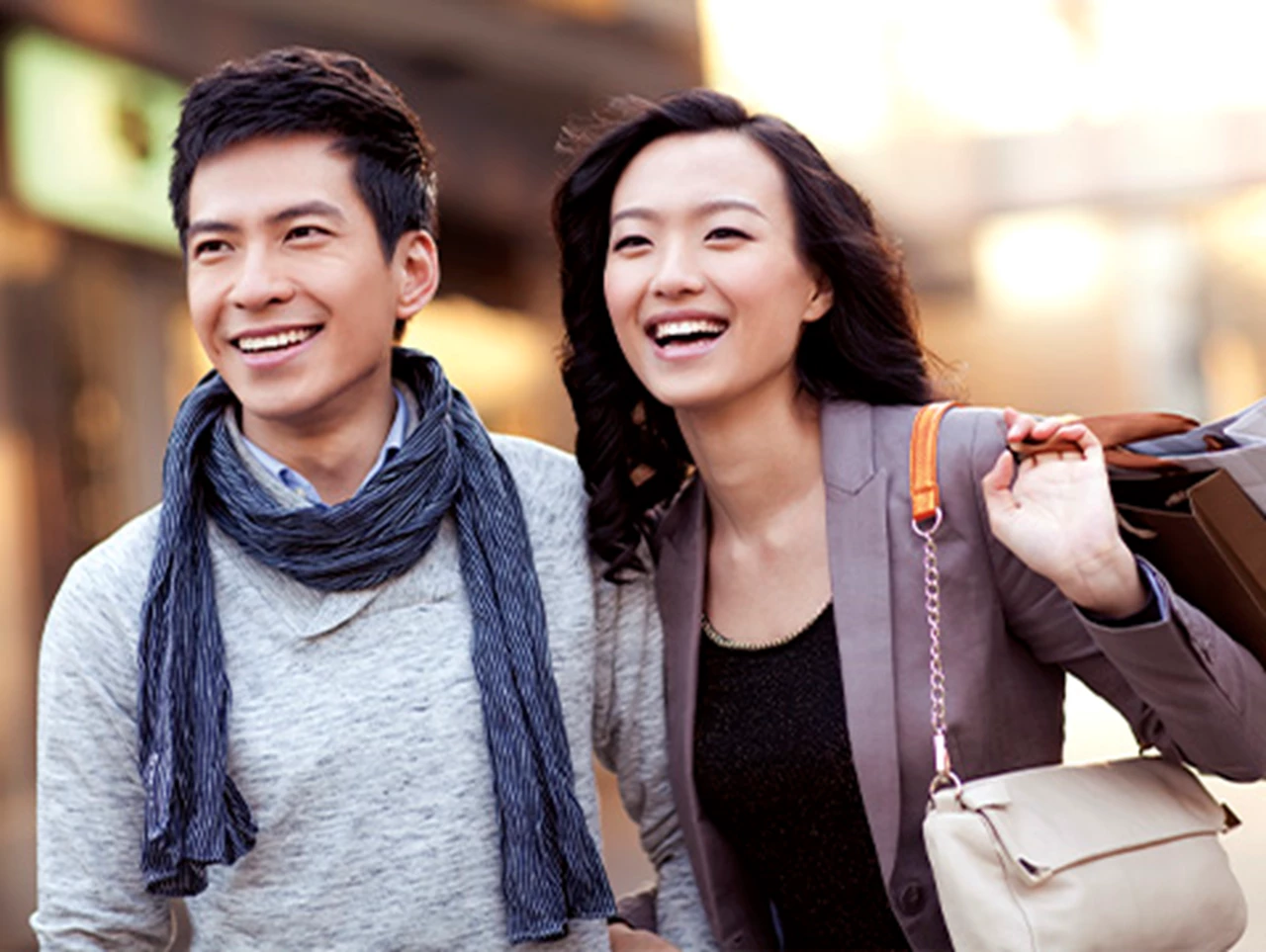 Asian couple smiling and walking